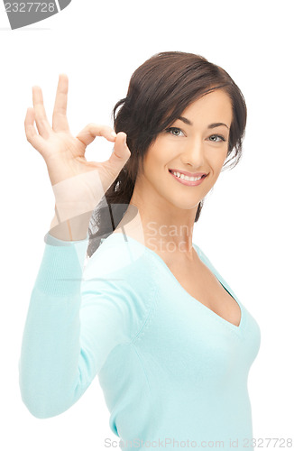 Image of lovely teenage girl showing ok sign