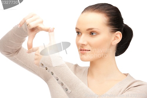 Image of lovely woman creating a frame with fingers