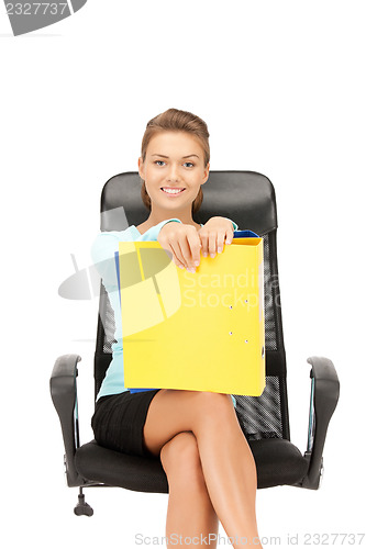 Image of young businesswoman with folders sitting in chair