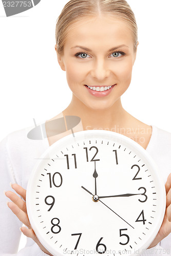 Image of woman holding big clock