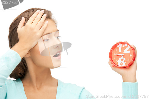 Image of woman holding alarm clock