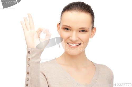 Image of lovely teenage girl showing ok sign