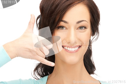 Image of woman making a call me gesture