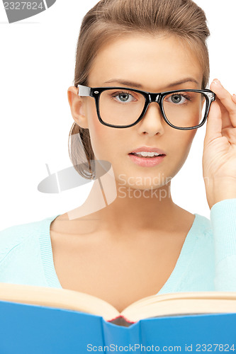 Image of calm and serious woman with book