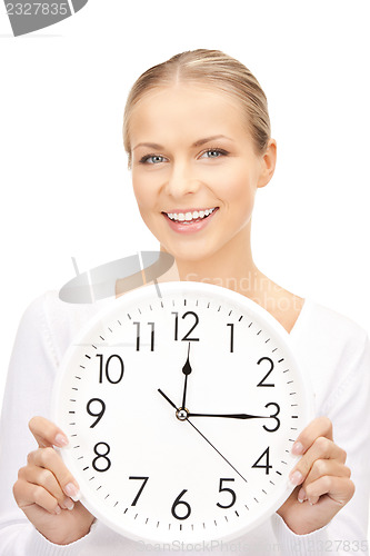 Image of woman holding big clock