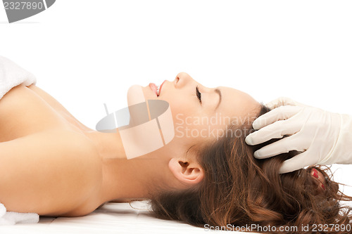 Image of beautiful woman in massage salon