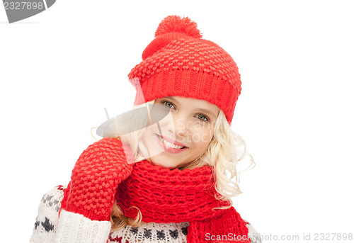 Image of beautiful woman in hat, muffler and mittens