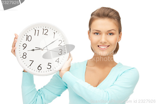 Image of woman holding big clock