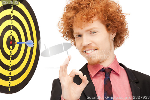 Image of businessman with dart and target