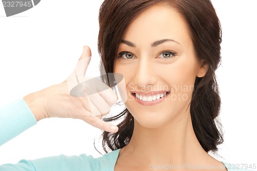 Image of woman making a call me gesture