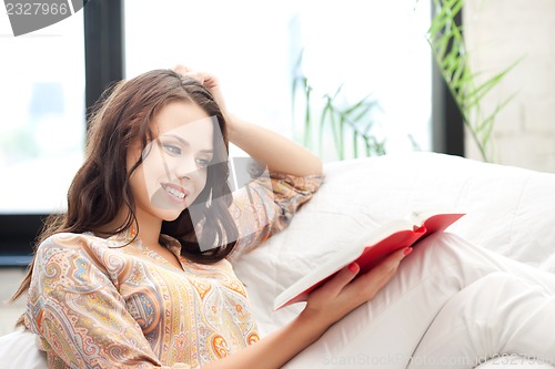 Image of happy and smiling woman with book