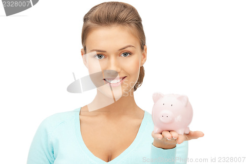 Image of lovely woman with piggy bank