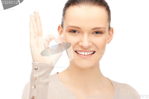 Image of lovely teenage girl showing ok sign