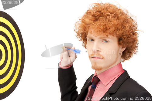 Image of businessman with dart and target