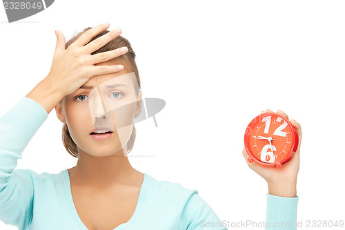 Image of woman holding alarm clock