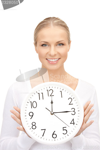 Image of woman holding big clock