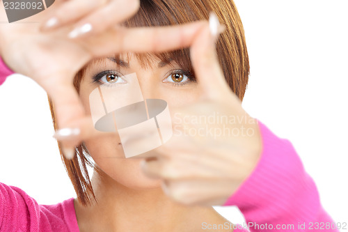 Image of lovely woman creating a frame with fingers