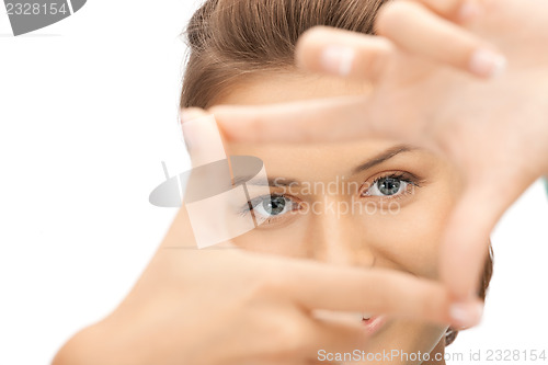 Image of lovely woman creating a frame with fingers