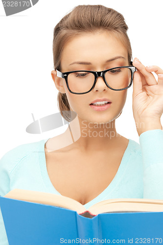 Image of calm and serious woman with book
