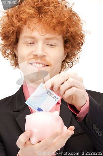 Image of man with piggy bank and money