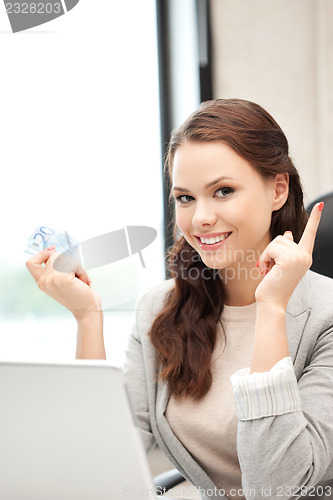Image of woman with laptop computer and euro cash money