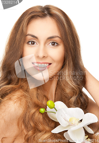 Image of beautiful woman with orchid flower