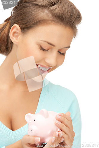 Image of lovely woman with piggy bank