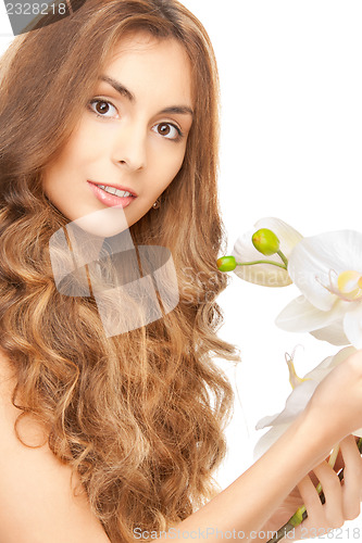 Image of beautiful woman with orchid flower