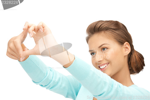 Image of lovely woman creating a frame with fingers