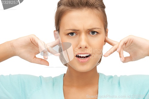 Image of woman with fingers in ears