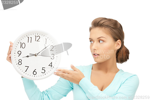 Image of woman holding big clock