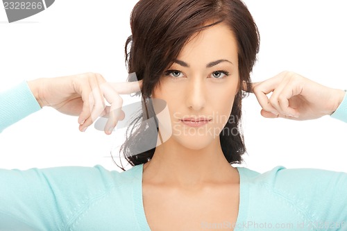 Image of woman with fingers in ears