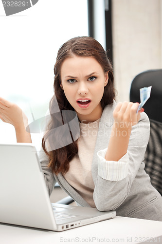 Image of unhappy woman with computer and euro cash money