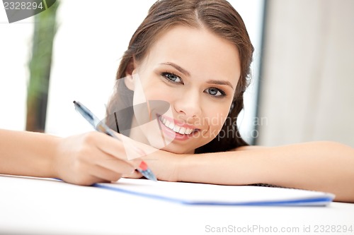 Image of happy woman with big notepad