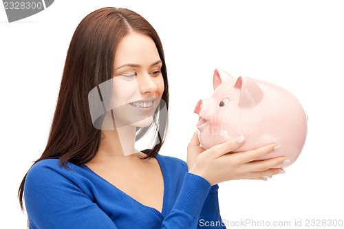 Image of lovely woman with piggy bank