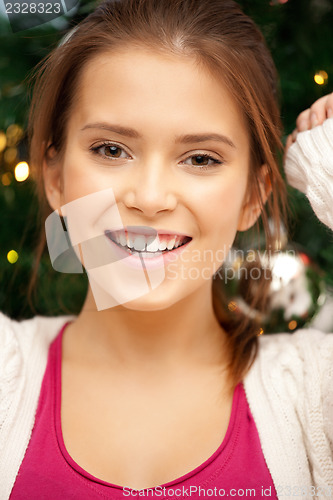 Image of happy and smiling woman with christmas tree
