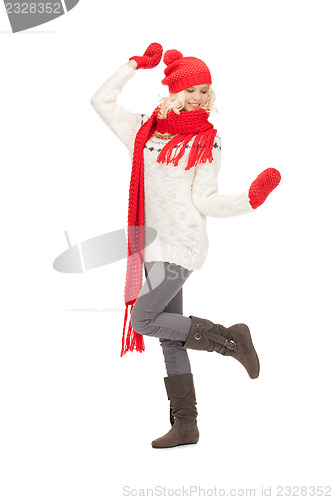 Image of beautiful woman in hat, muffler and mittens