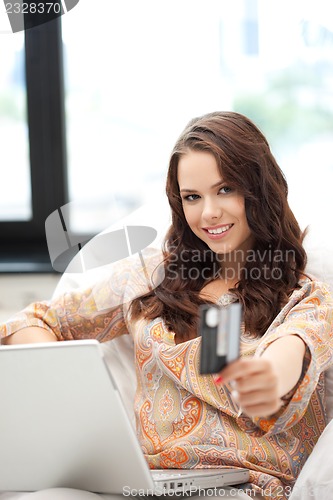 Image of happy woman with laptop computer and credit card