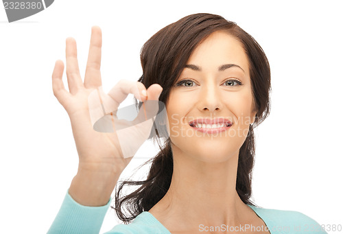 Image of lovely teenage girl showing ok sign