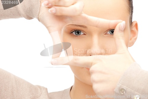 Image of lovely woman creating a frame with fingers