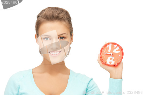 Image of woman holding alarm clock