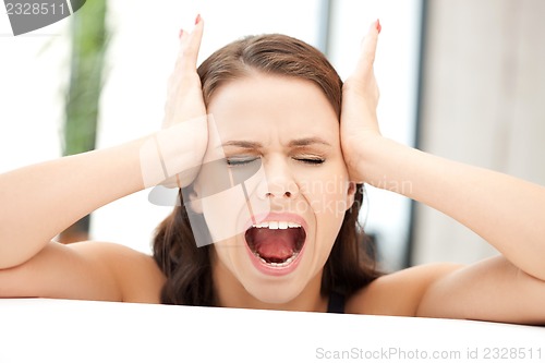 Image of woman with hands on ears