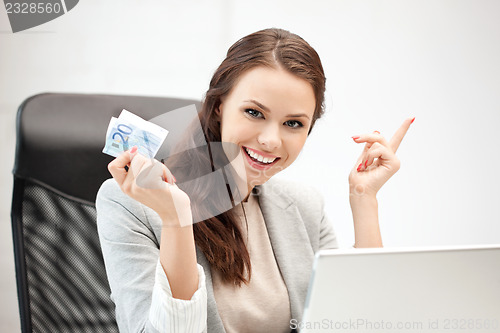 Image of woman with laptop computer and euro cash money