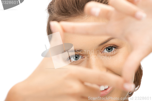 Image of lovely woman creating a frame with fingers