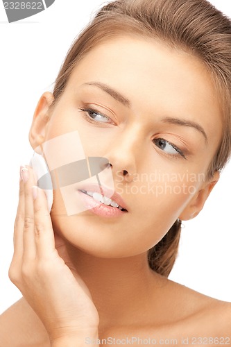 Image of beautiful woman with cotton pad
