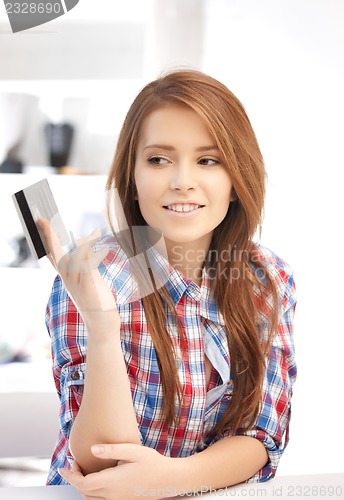 Image of pensive woman with credit card