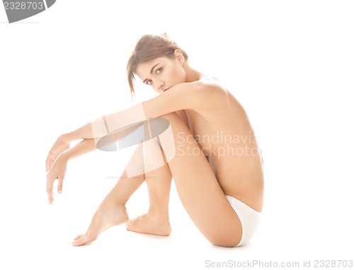 Image of beautiful topless woman in panties