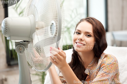 Image of happy woman with big fan