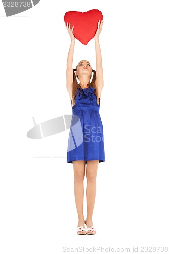 Image of lovely woman with red heart-shaped pillow