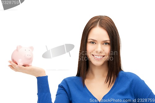 Image of lovely woman with piggy bank